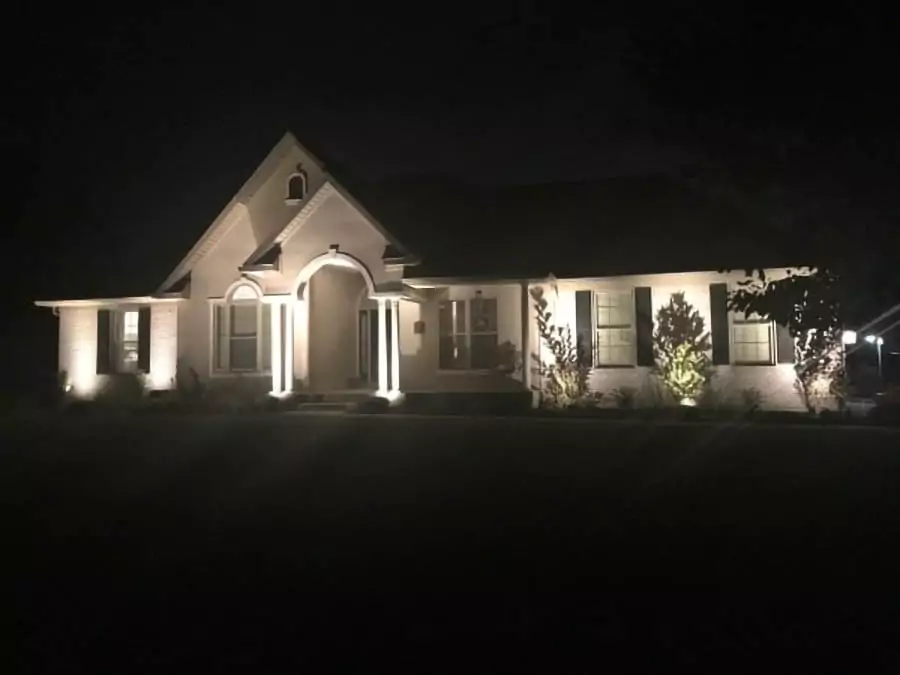 house lit up at night with landscape lighting