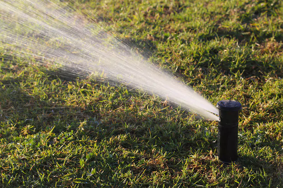 In a green lawn sprinkler system installed that watering
