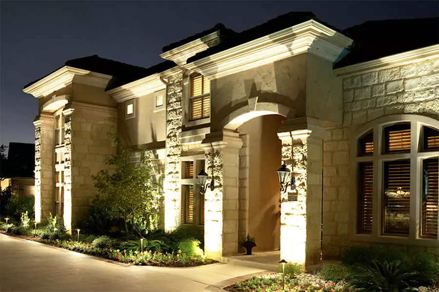 Elegant architectural lighting highlighting the exterior of a luxury stone home at night in Indianapolis