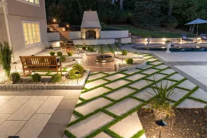 Indianapolis outdoor lighting with modern patio design, fireplace, seating area, and glare-free landscape illumination