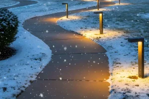 Energy-efficient pathway lighting illuminating a snow-covered walkway in Indianapolis during winter