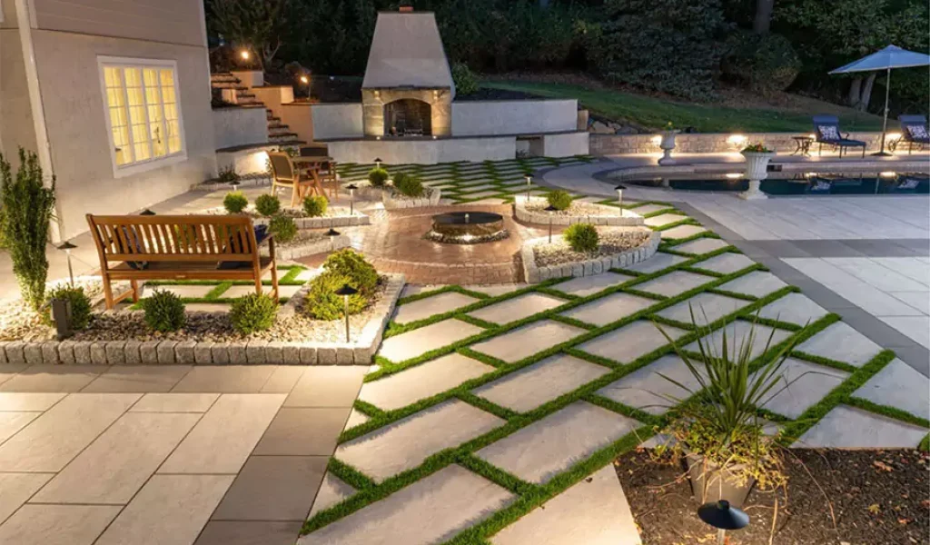 Indianapolis outdoor lighting with modern patio design, fireplace, seating area, and glare-free landscape illumination