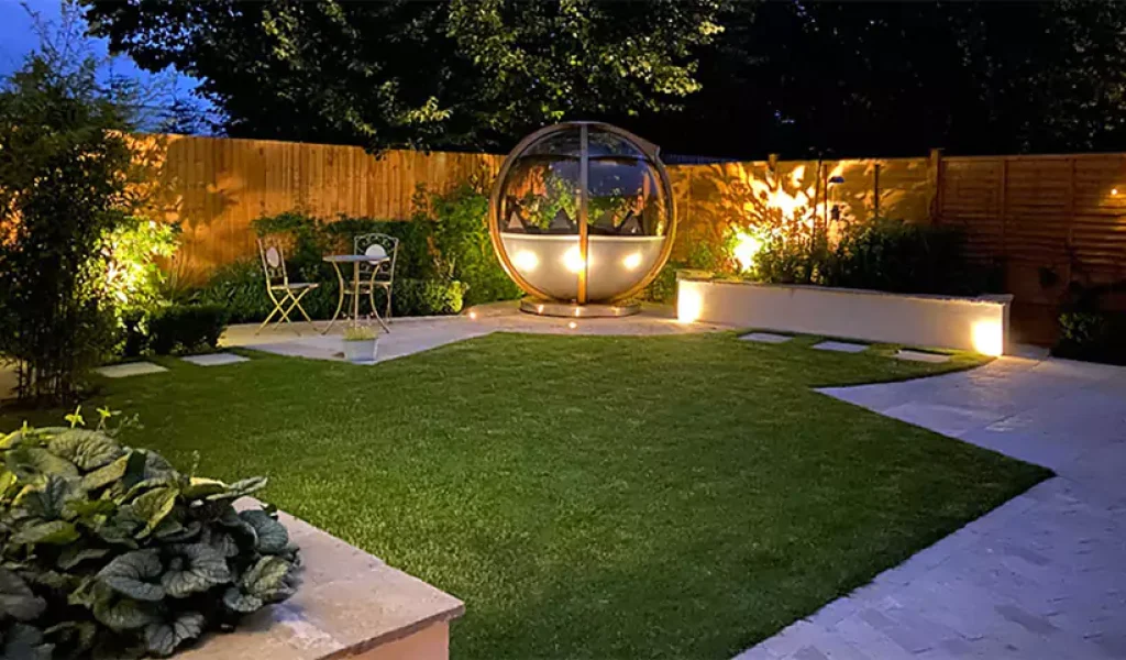 Beautifully lit backyard with outdoor lighting installation, showcasing safety standards in Indianapolis, IN.