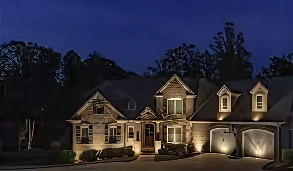 Luxury suburban home exterior with elegant architectural lighting at night, showcasing enhanced curb appeal and security. Ideal for winter lighting upgrades in Indianapolis.