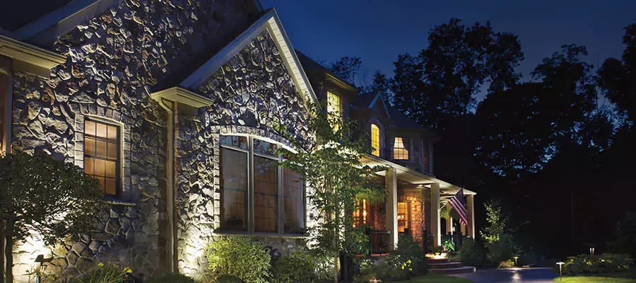 rock house with outdoor lights and a walkway
