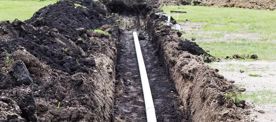 trench with pipe in middle for sprinkler system